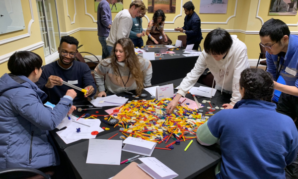 PhD students gathered around a box of K'Nex to design andbuild a racing car.